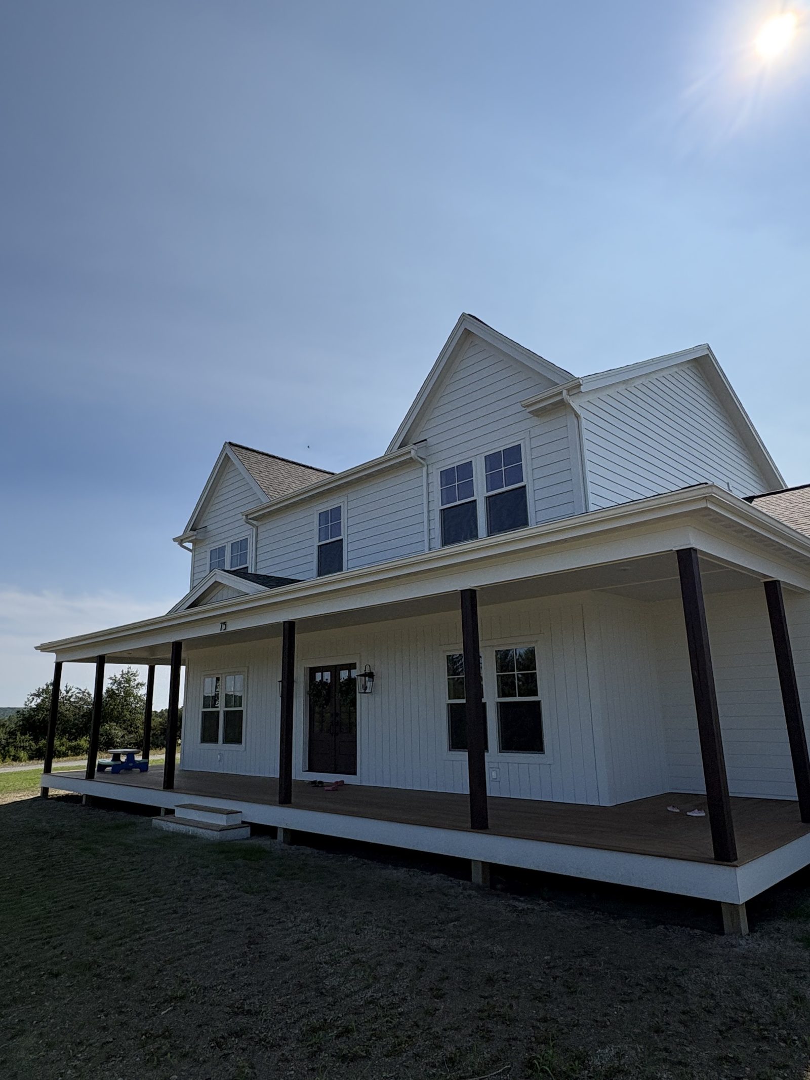 Custom farmhouse exterior with new siding
