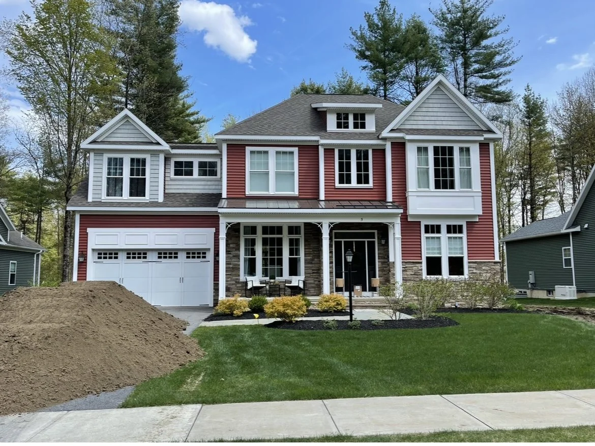 Two-story home with new red and gray siding